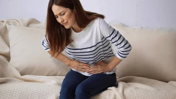Woman Closed Eyes Suffering Stomach Pain While Sitting Sofa — Stock Photo, Image