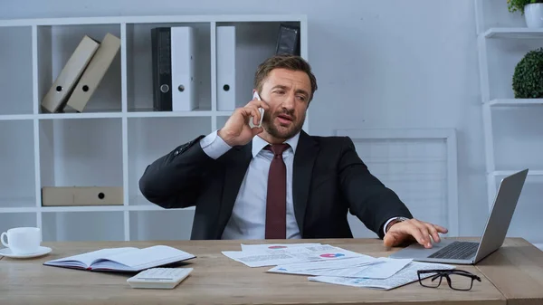 Businessman Talking Mobile Phone Laptop Papers Desk — Stock Photo, Image
