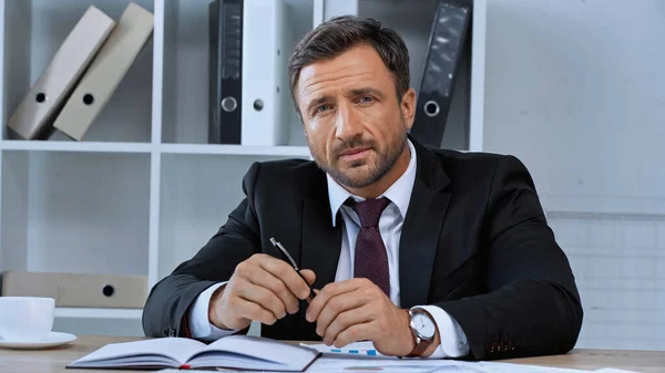 Businessman Holding Pen Looking Camera While Sitting Work Desk — Stock Photo, Image