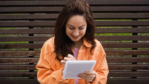 Mujer Complacida Usando Tableta Digital Mientras Está Sentado Banco Madera — Foto de Stock