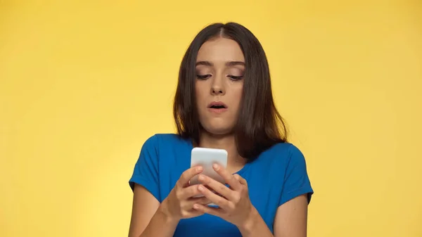 Young Brunette Woman Blue Shirt Grimacing While Typing Smartphone Isolated — Foto de Stock