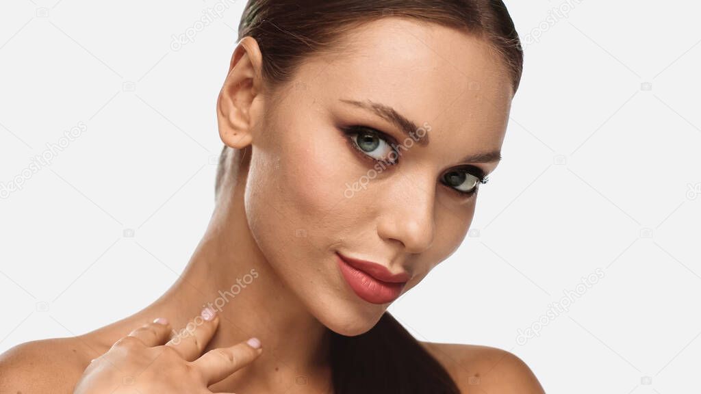 brunette young woman with eye liner and mascara looking at camera isolated on white 