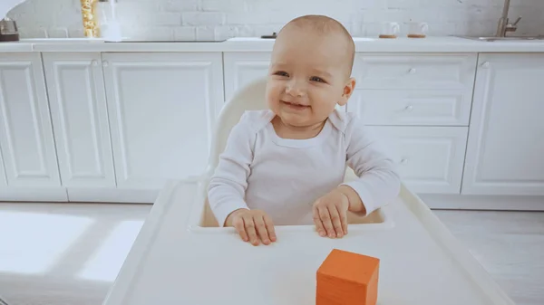 Happy Baby Girl Sitting Feeding Chair Orange Wooden Cube — Stock Photo, Image