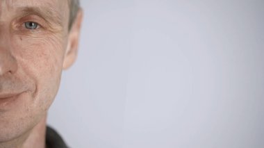 cropped view of cheerful middle aged man looking at camera isolated on grey with copy space