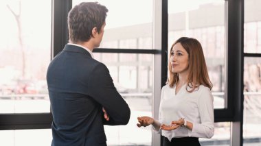 surprised and positive woman talking to employer during job interview