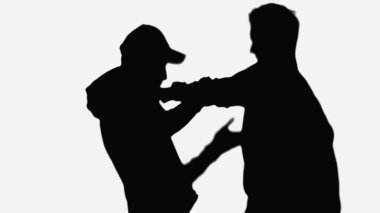 side view of man fighting with robber in cap isolated on white