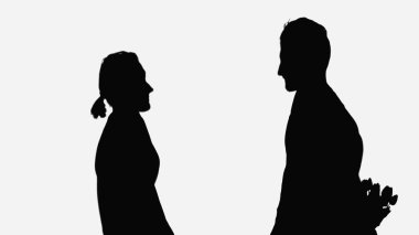 black silhouette of man holding bouquet behind back near woman isolated on white