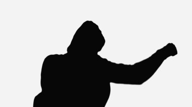 black silhouette of boxer in hood training isolated on white clipart