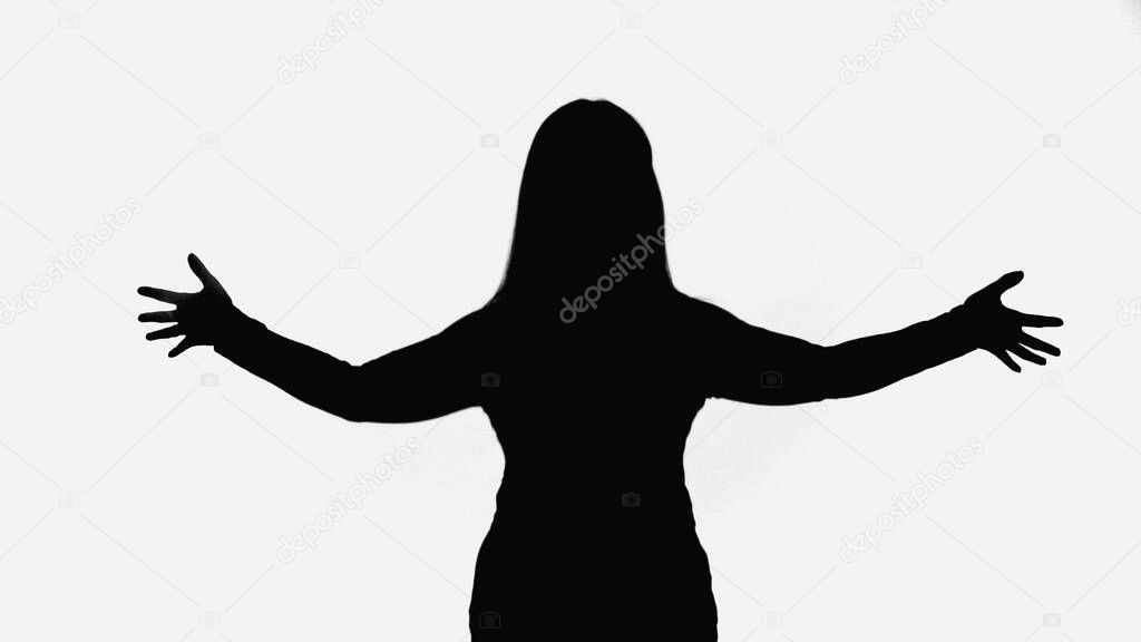 black silhouette of woman standing with open arms isolated on white