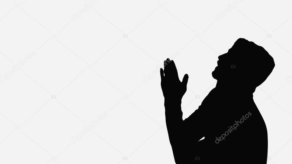 black shadow of man with praying hands isolated on white
