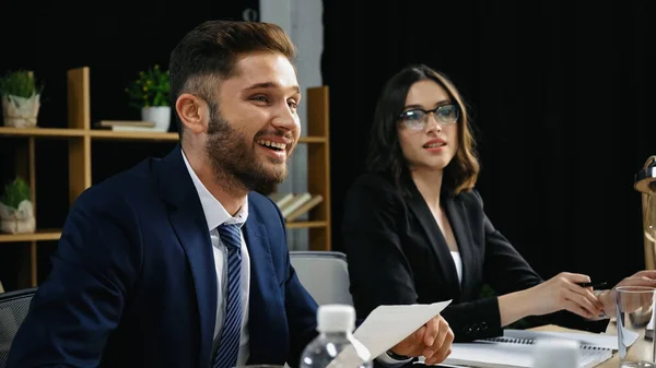Young business people in formal wear smiling in meeting room — Stock Photo