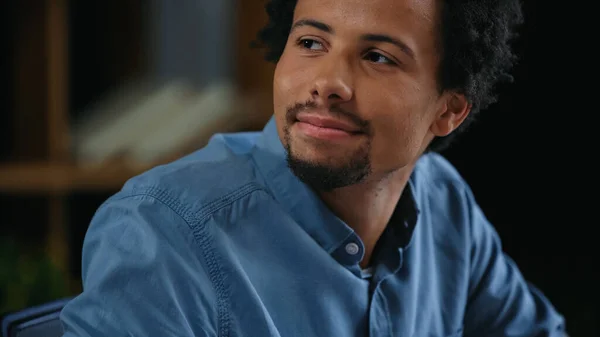 Young african american businessman in blue shirt looking away in office — Stock Photo