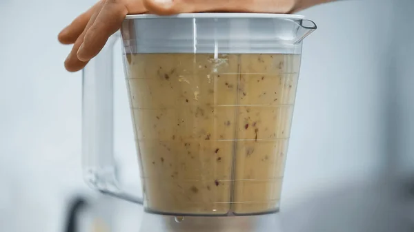 Partial view of man preparing fresh smoothie in electric blender — Stock Photo