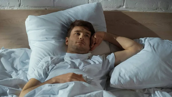 Man lying in bed and suffering from insomnia — Stock Photo