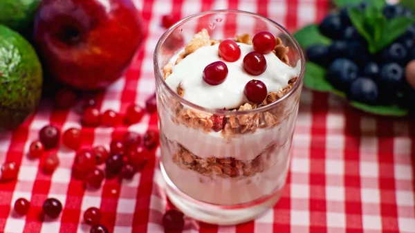 Cranberries on top of fresh yogurt with granola — Stock Photo