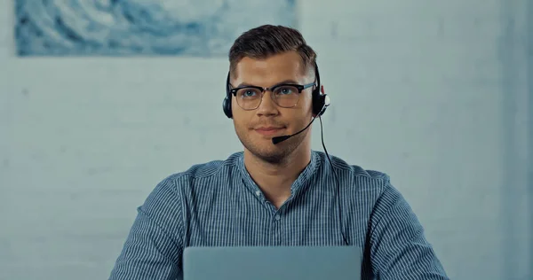 Телефонний працівник в гарнітурі з мікрофоном і окулярами, що працюють з дому — стокове фото
