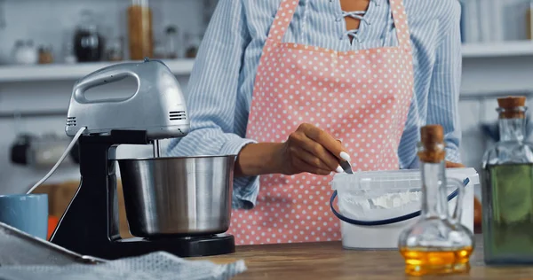 Cropped view of woman near food processor and container with flour in kitchen — Stock Photo