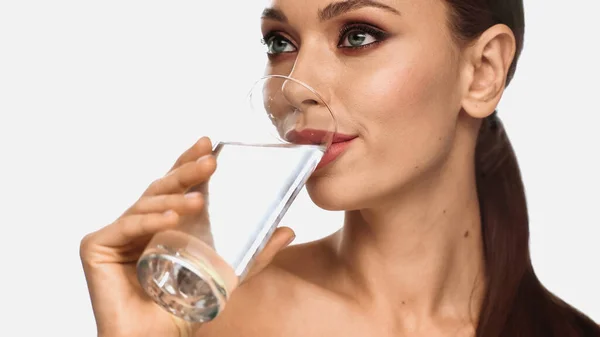 Portrait of brunette young woman with makeup drinking water isolated on white — Stock Photo