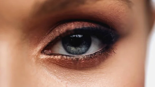 Close up view of young woman with grey eye and makeup looking at camera — Photo de stock