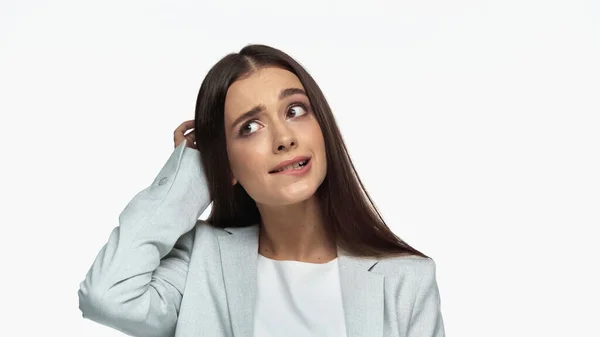 Puzzled businesswoman in grey blazer touching head isolated on white — Stockfoto