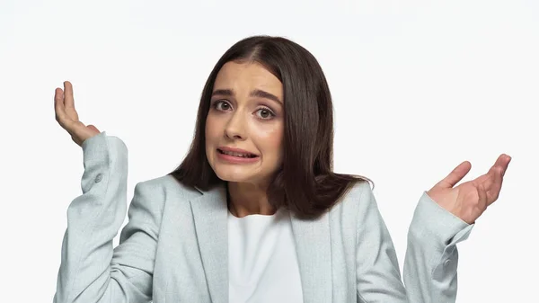 Confused businesswoman in grey blazer showing shrug gesture isolated on white - foto de stock