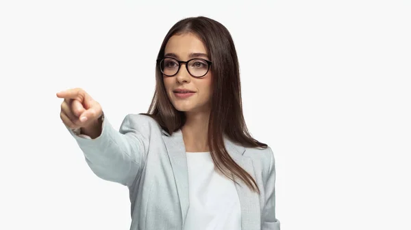 Successful businesswoman in grey jacket and eyeglasses pointing with finger isolated on white — Stockfoto