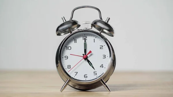 Metallic and vintage alarm clock on wooden table isolated on grey — Photo de stock