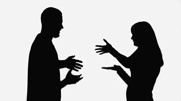 Black silhouettes of couple quarreling and gesturing isolated on white — Fotografia de Stock