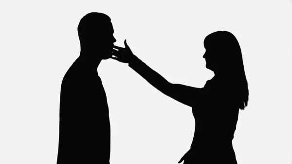 Shadow of wife giving slap to husband while quarreling isolated on white — стоковое фото