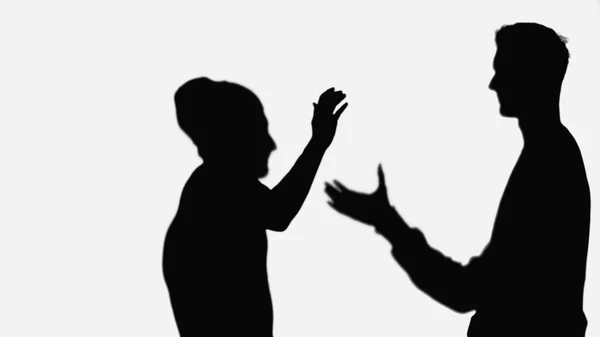 Чорні силуети друзів вітають один одного під час зустрічі ізольовані на білому — стокове фото