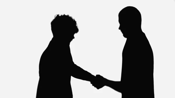 Black silhouettes of businessmen shaking hands isolated on white — стоковое фото