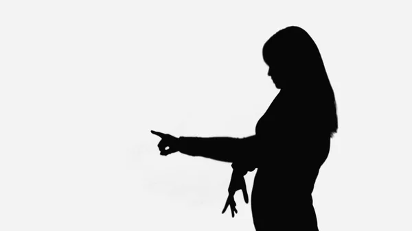 Black shadow of woman pointing with finger isolated on white - foto de stock