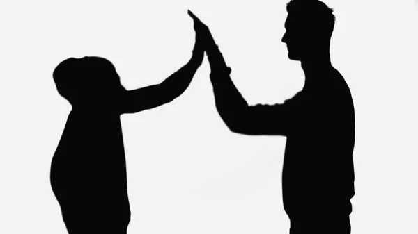 Black silhouettes of friends giving high five isolated on white — Photo de stock
