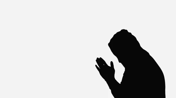 Silhouette of monk in hood praying isolated on white — Foto stock