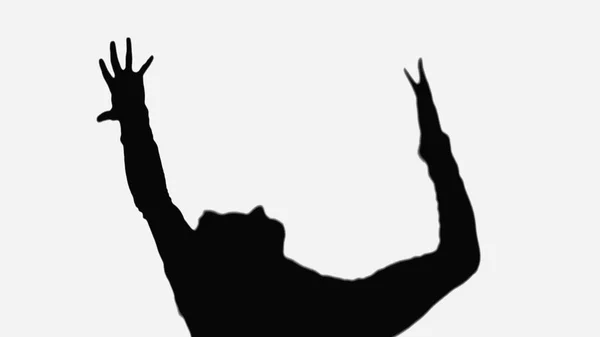 Shadow of man showing rejoice gesture with raised hands isolated on white — Stock Photo