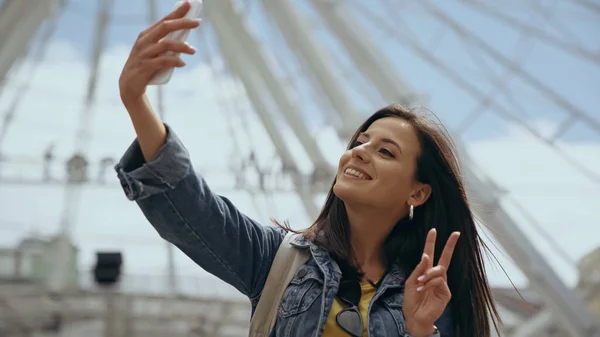 Smiling traveler taking selfie on smartphone on urban street — Foto stock