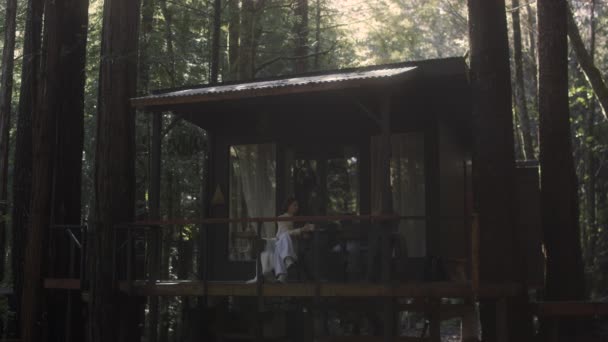 Young Woman Reading Book Drinking Hot Tea Porch Cozy Cabin Videoclip