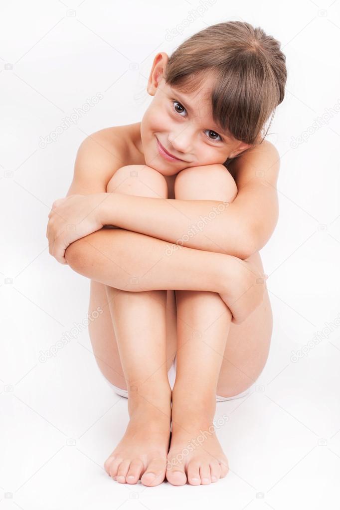 Nude woman sitting with knees up, front view. Stock Image 