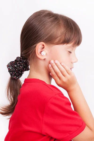 Girl with ear plugs in your ears — Stock Photo, Image