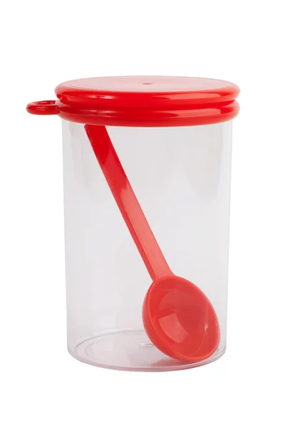 Plastic jar with a spoon inside — Stock Photo, Image