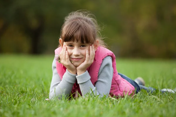 Charming little girls lying grass Stock Picture