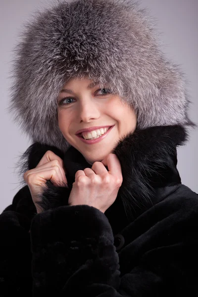 Beautiful woman in a fur hat — Stock Photo, Image