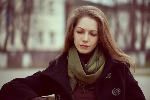 Cute young long-haired woman grieves — Stock Photo, Image