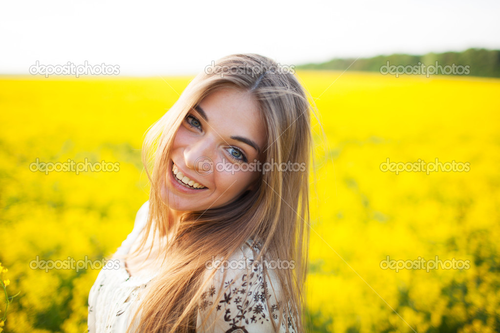 Beautiful young woman of yellow wildflowers