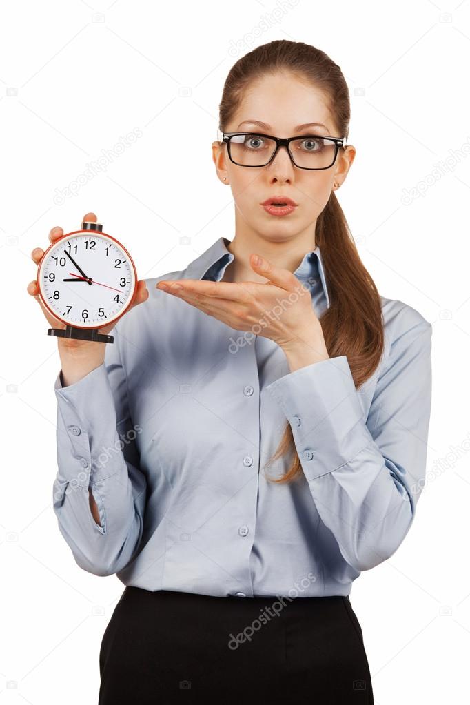 Surprised girl shows the alarm clock