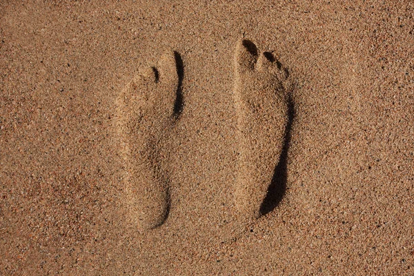 Traces of human feet in the sand