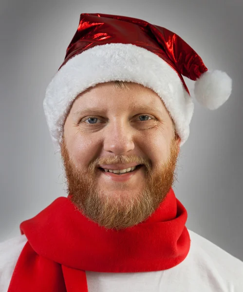 Man in a Santa Claus hat and red scarf — Stock Photo, Image