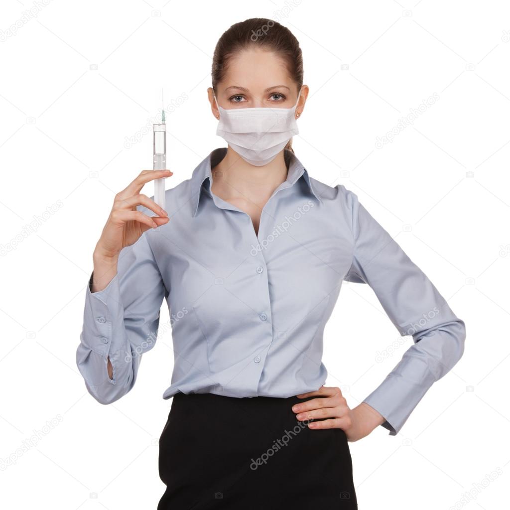 Woman in medical mask with syringe