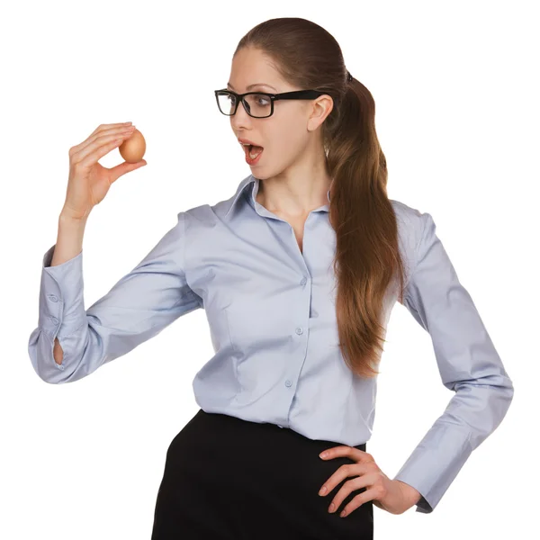 Young woman in glasses holding a chicken egg — Stock Photo, Image