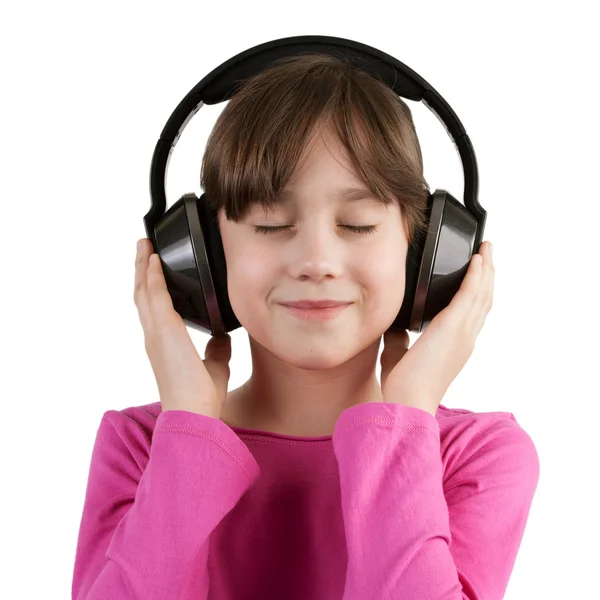 Meisje plezier luisteren naar muziek op hoofdtelefoon — Stockfoto